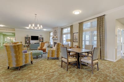 Bright common area with seating and a dining table