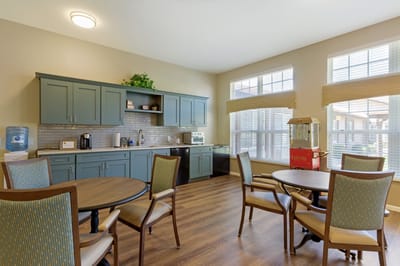 Bright common area with seating and kitchen amenities
