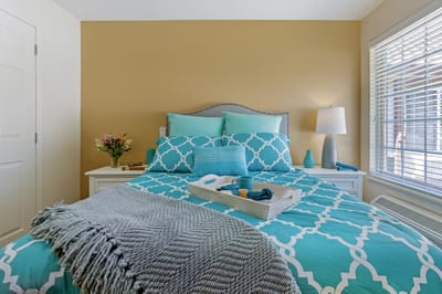 Cozy resident bedroom with decorative bedding