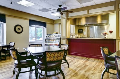 Interior view of a dining area with tables and kitchenette