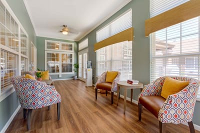 Bright common area with comfortable seating for residents