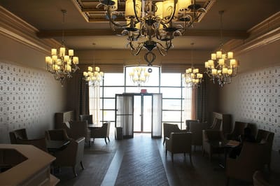 Bright lounge area with chandeliers and seating