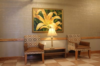 Cozy lobby area with floral artwork and comfortable chairs