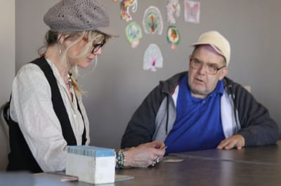 Resident engaging in activity with staff member