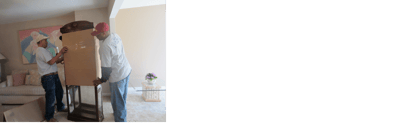 Two men moving furniture inside a bright living space