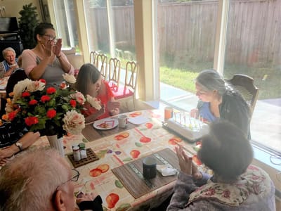 Residents celebrating a birthday with a cake