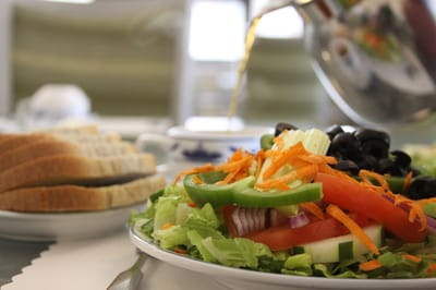 Close-up of a fresh salad with bread in a dining area