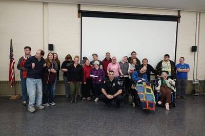 Group photo of residents and staff in a common area