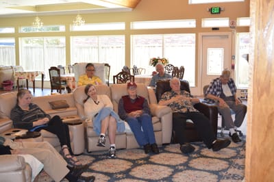 Residents enjoying a movie in a common area