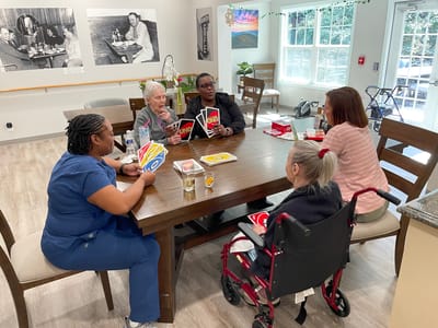Residents enjoying a game of Uno in a common area