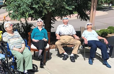 Residents enjoying the sun on a patio