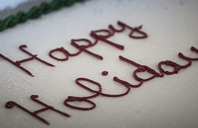 Close-up of a cake with 'Happy Holidays' written on it