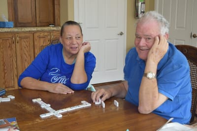 Residents enjoying a game of dominoes in a common area