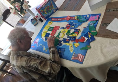 Resident engaged in a puzzle activity indoors
