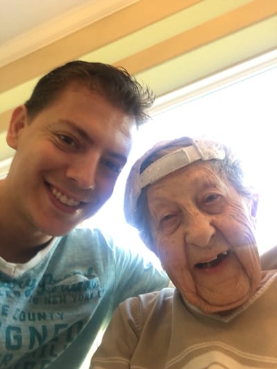 A resident and staff member smiling together