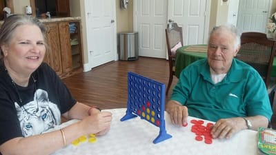 Residents playing a board game in the common area