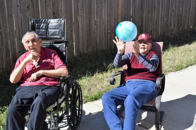 Two residents enjoying time outdoors on a sunny day
