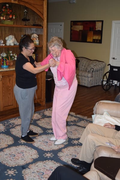 Staff assisting a resident in a common area