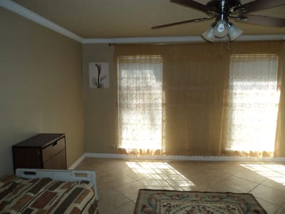 Bright interior room with large windows and furniture