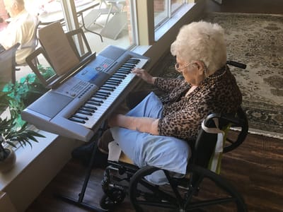 Resident playing keyboard in a common area