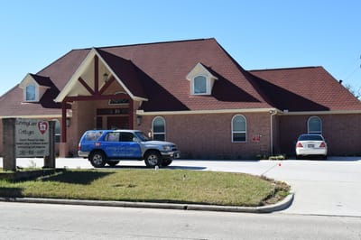Exterior view of Loving Care Cottage with vehicles