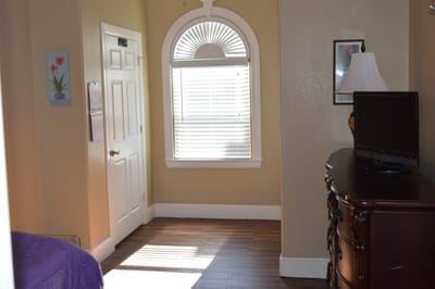 Cozy resident room with a window and wooden floor