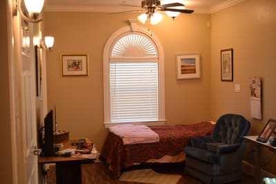 Private resident room with a bed and seating area
