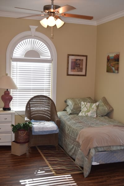 Cozy private room with a bed and chair