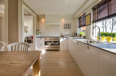 Modern kitchen interior with white cabinetry and sunlight