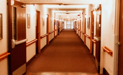 Long interior hallway with resident rooms.