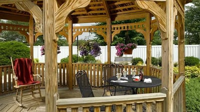 Wooden gazebo with seating and flowers