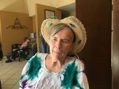 Resident in a common area wearing a straw hat