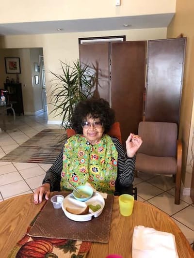 Resident enjoying a meal in a dining area
