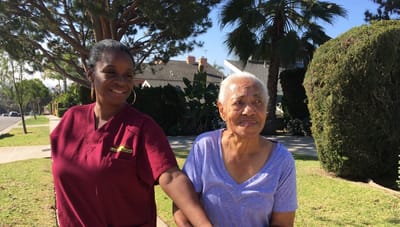 Staff member assisting a resident outdoors