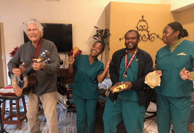 Residents and staff enjoying a musical activity indoors