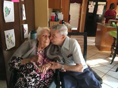 Two elderly residents sharing a moment in a common area
