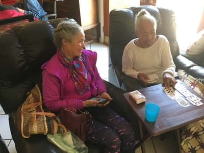 Residents playing cards in a lounge area