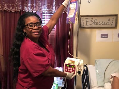 Staff member assisting a resident with IV medication