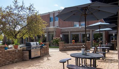 Outdoor patio area with seating and grill