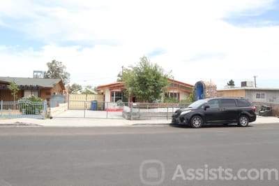 Exterior view of a group home building and parking area