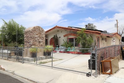 Exterior view of a senior living facility with a fenced area