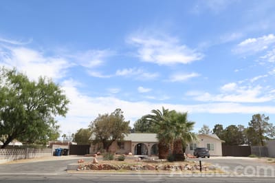 Exterior view of A and J Care Home with palm trees
