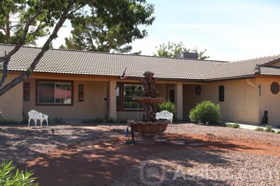 Exterior view of a senior care facility with a fountain