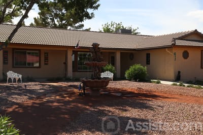 Exterior view of a senior living facility with a fountain