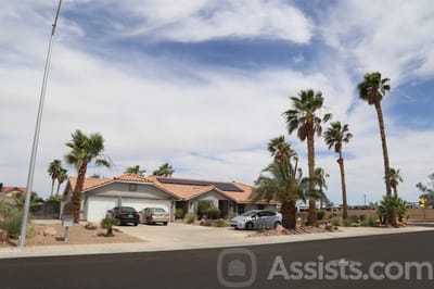 Exterior view of a residential building with palm trees