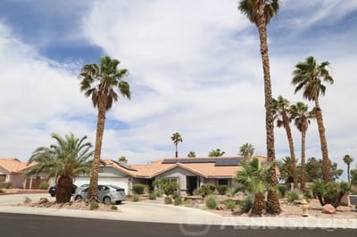 Exterior view of a residential building with palm trees