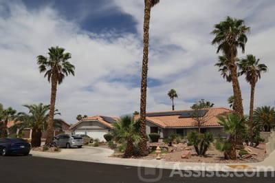 Exterior view of a residential building with palm trees