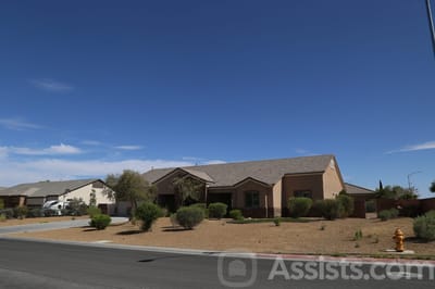 Exterior view of a senior living facility with landscaping