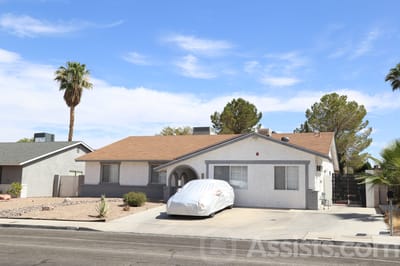Exterior view of a senior care facility with a covered vehicle