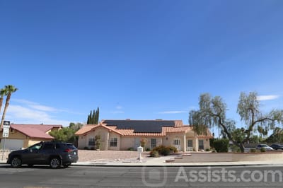 Exterior view of Palms Care Home with outdoor landscaping